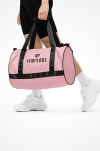 Baby pink rounded end Gymplode duffle bag with dual mark, front view with model