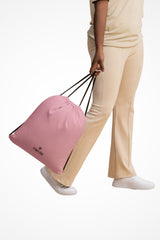Candy pink lightweight drawstring bag with Gymplode dual mark imprint, front view with model