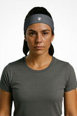 Carbon grey Gymplode headband with icon logo, worn by female model