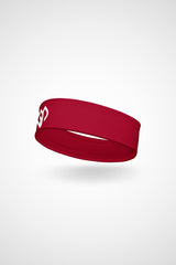 Cherry red Gymplode headband with icon logo, angled view