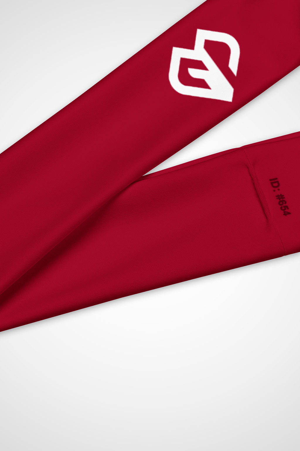 Close-up view of Gymplode icon logo on cherry red headband