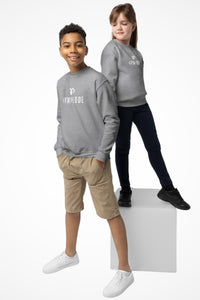 Cozy youth unisex Gymplode crewneck sweatshirt with dual mark imprint, front view with model