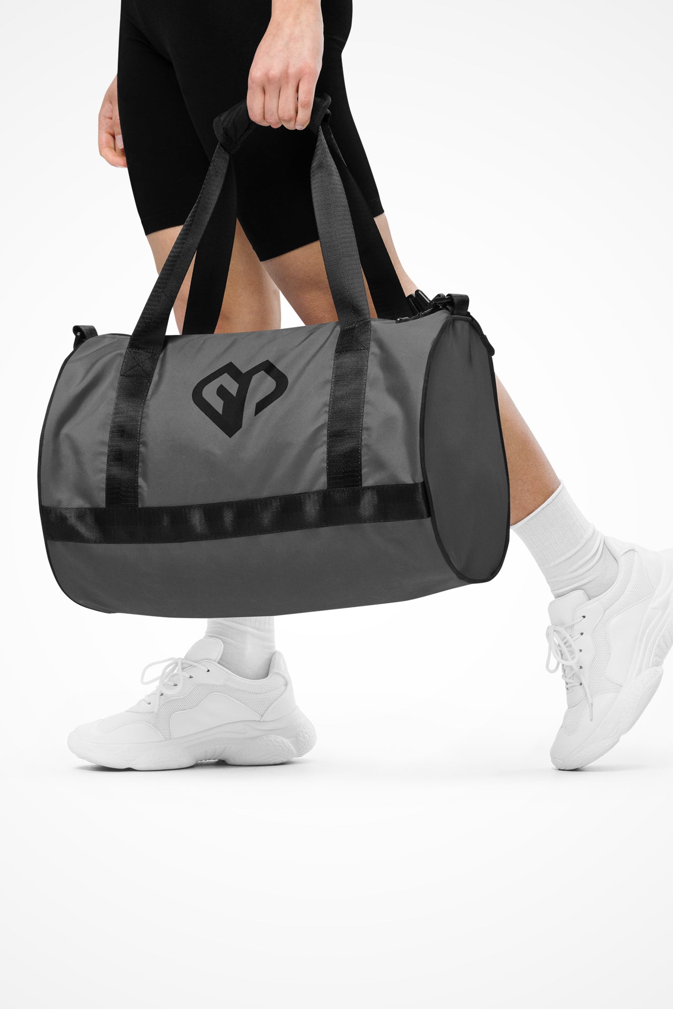 Dusky grey rounded end Gymplode duffle bag with icon logo, front view with model