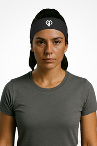 Graphite Gymplode headband with icon logo, worn by female model