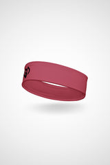 Hippie pink Gymplode headband with icon logo, angled view