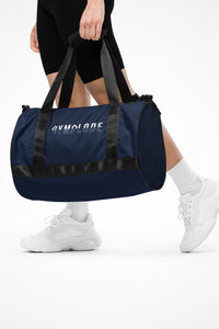 Navy blue rounded end Gymplode duffle bag with signature logo, front view with model