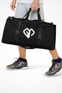 Onyx black square end Gymplode duffle bag with icon logo, front view with model