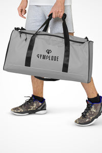 Pale grey square end Gymplode duffle bag with dual mark, front view with model