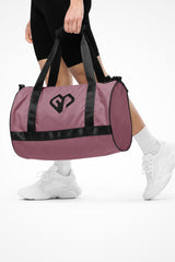 Rosewood rounded end Gymplode duffle bag with icon logo, front view with model