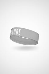 Silver Gymplode headband with signature logo, angled view