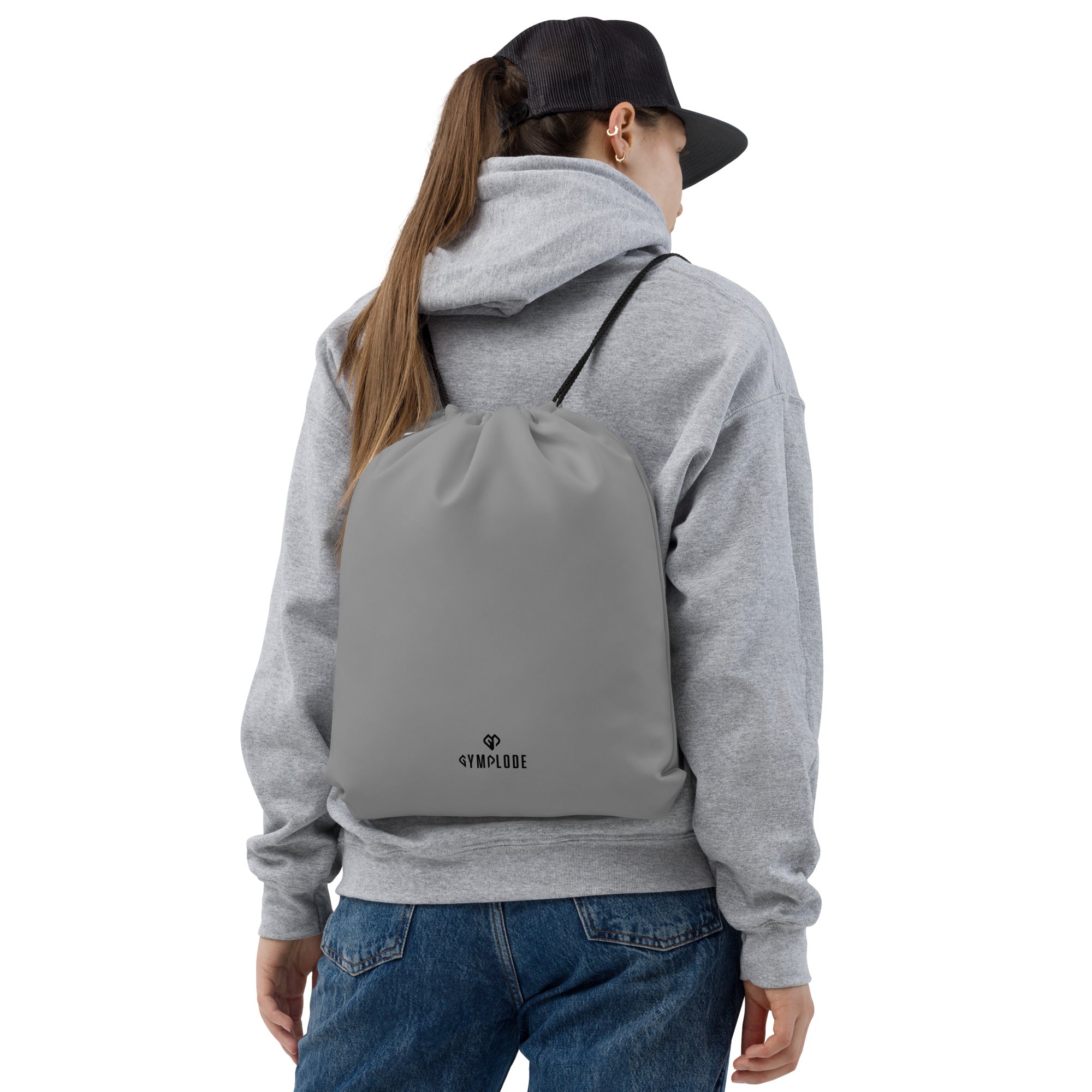 Smoke grey lightweight drawstring bag with Gymplode dual mark imprint worn as backpack by female model