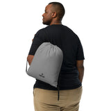 Smoke grey lightweight drawstring bag with Gymplode dual mark imprint worn as backpack by male model
