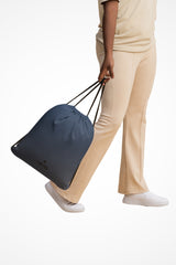 Storm blue lightweight drawstring bag with Gymplode dual mark imprint, front view with model