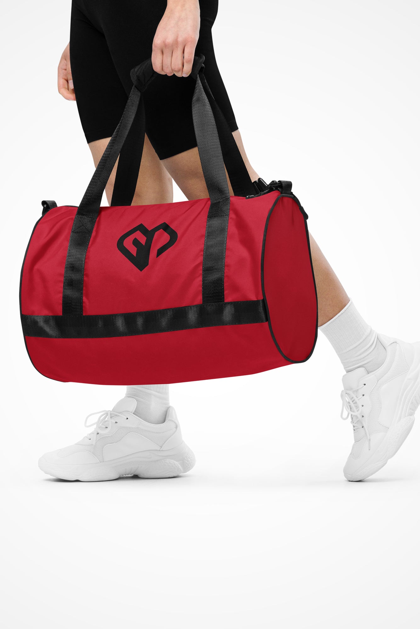 Sunset red rounded end Gymplode duffle bag with icon logo, front view with model