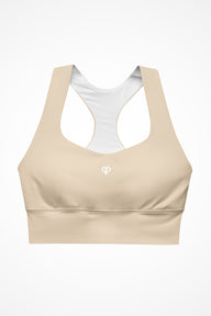 Womens beige longline sports bra with Gymplode icon logo, front view