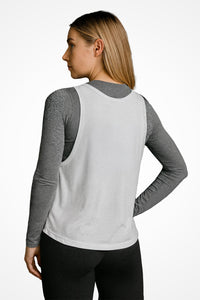 Womens white GS3 relaxed fit Gymplode tank top with no print, back view with model